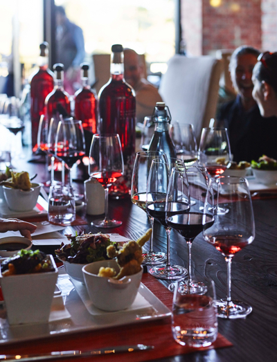 Wood table set with Blackbird Wines and Morimoto Napa food